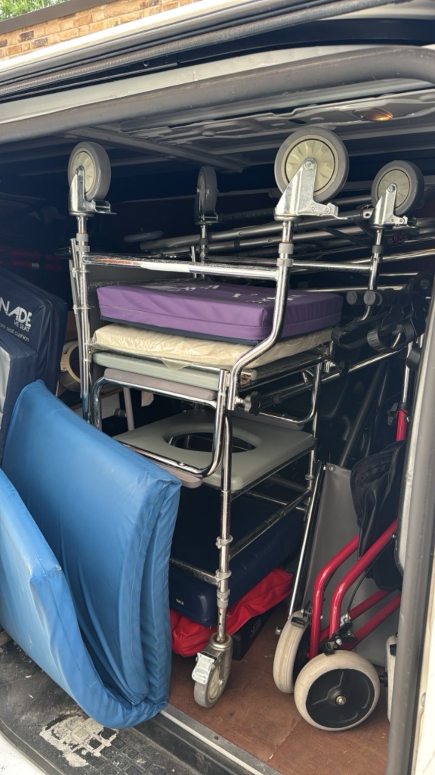 Donated commode chairs, cushions and mobility equipment loaded for transport